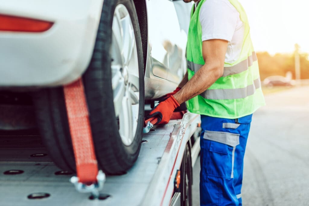 Handsome middle age man working in towing service on the road. Roadside assistance concept.